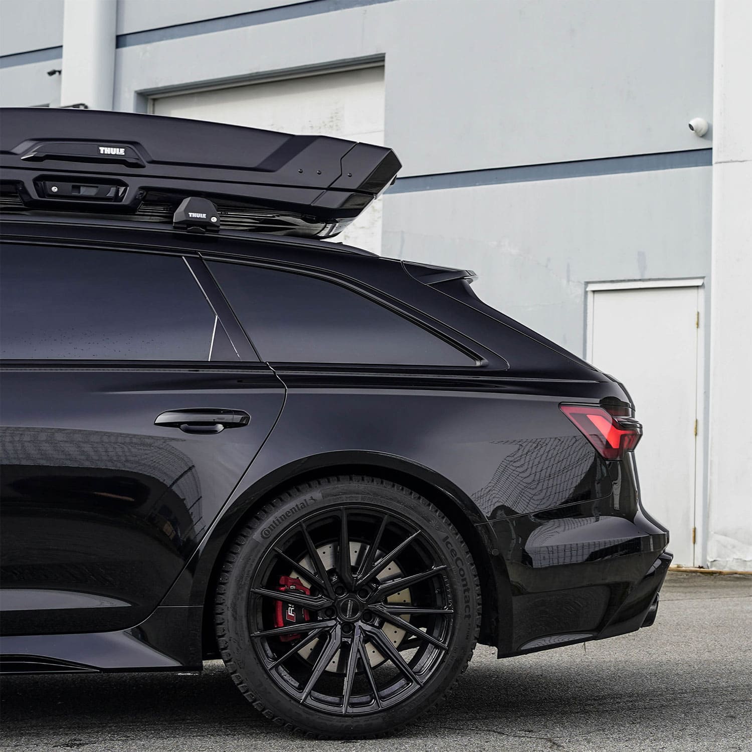Side profile of a black car showing ChroMorpher Chrome Delete Tape application on window trim and rear panels, creating a seamless, sleek finish.