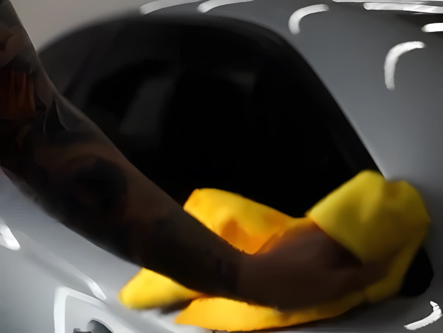 Installer wiping down finished chrome delete trim with microfiber cloth after applying ChroMorpher Tape.