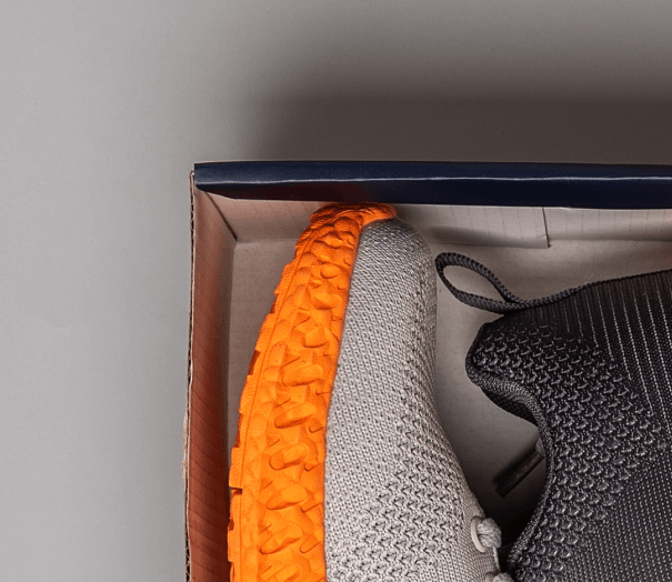 Close-up of a black side mirror on a white Mercedes-Benz coupe.