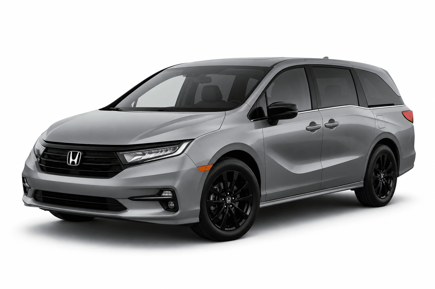 A silver Honda Odyssey minivan with black wheels, shown from a three-quarter front angle on a white studio background.