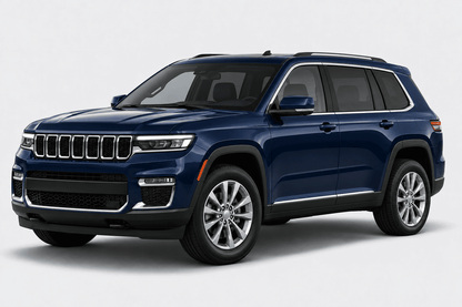 A dark blue Jeep Grand Cherokee SUV shown from a three-quarter front angle against a light gray studio background.