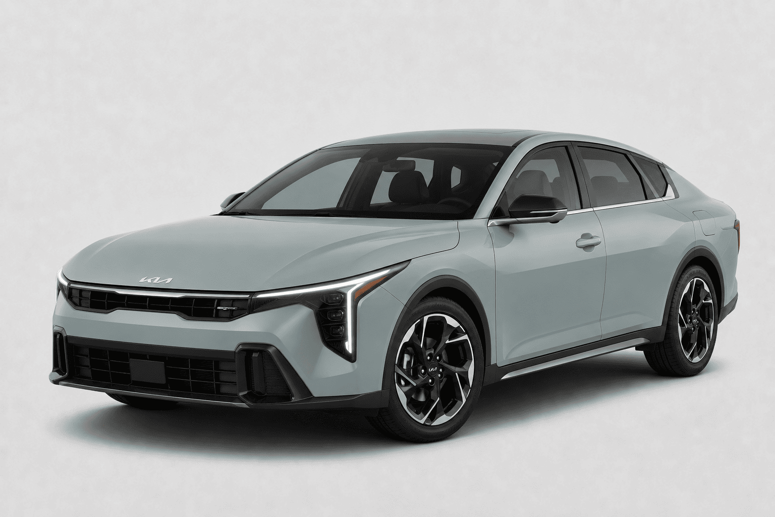 A light gray Kia sedan shown at a three-quarter front angle on a clean, light gray studio background.