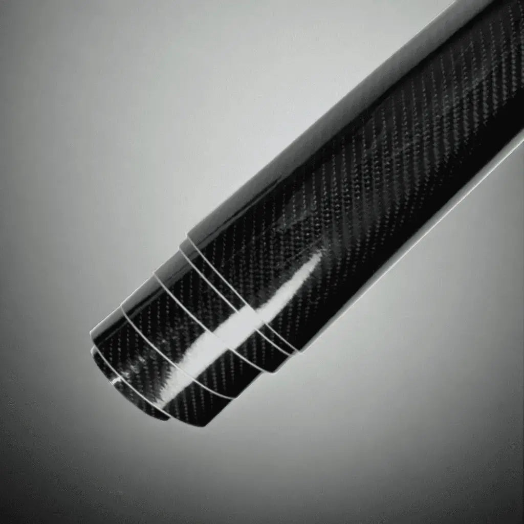 Detailed view of Large ChroMorpher Carbon Fiber Roll, showcasing its glossy carbon fiber finish with precision wrap layering for automotive customization