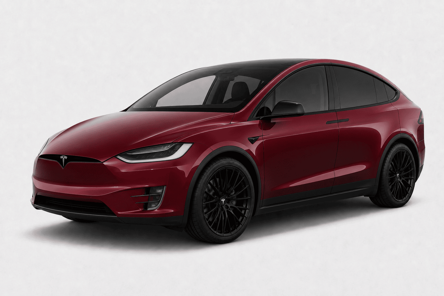 A Tesla Model X in metallic deep red with black wheels and a black roof, shown from a three-quarter front angle on a light gray background.
