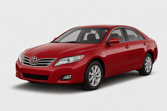 A red Toyota Camry sedan shown from a three-quarter front angle on a light gray studio background.