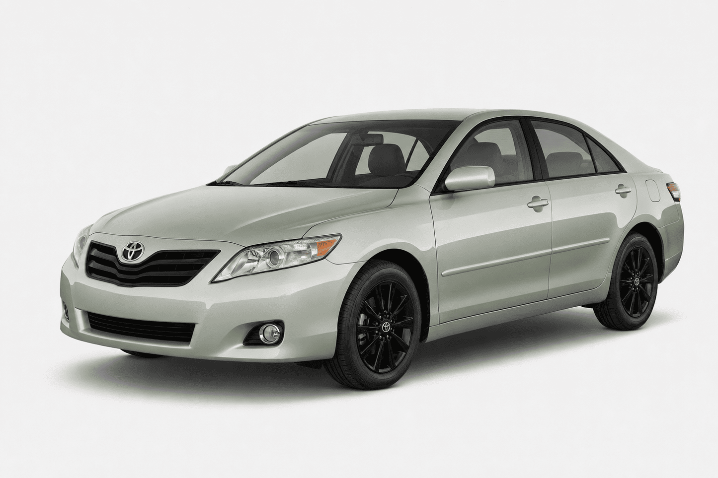 A silver Toyota Camry sedan with black wheels, shown from a three-quarter front angle on a light gray studio background.