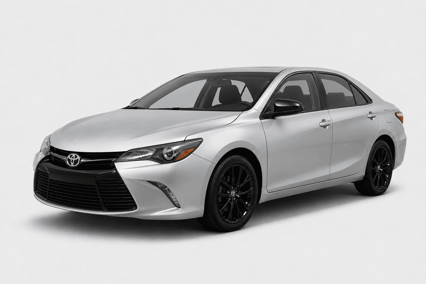 A silver Toyota Camry sedan with black wheels, shown from a three-quarter front angle on a light gray studio background.