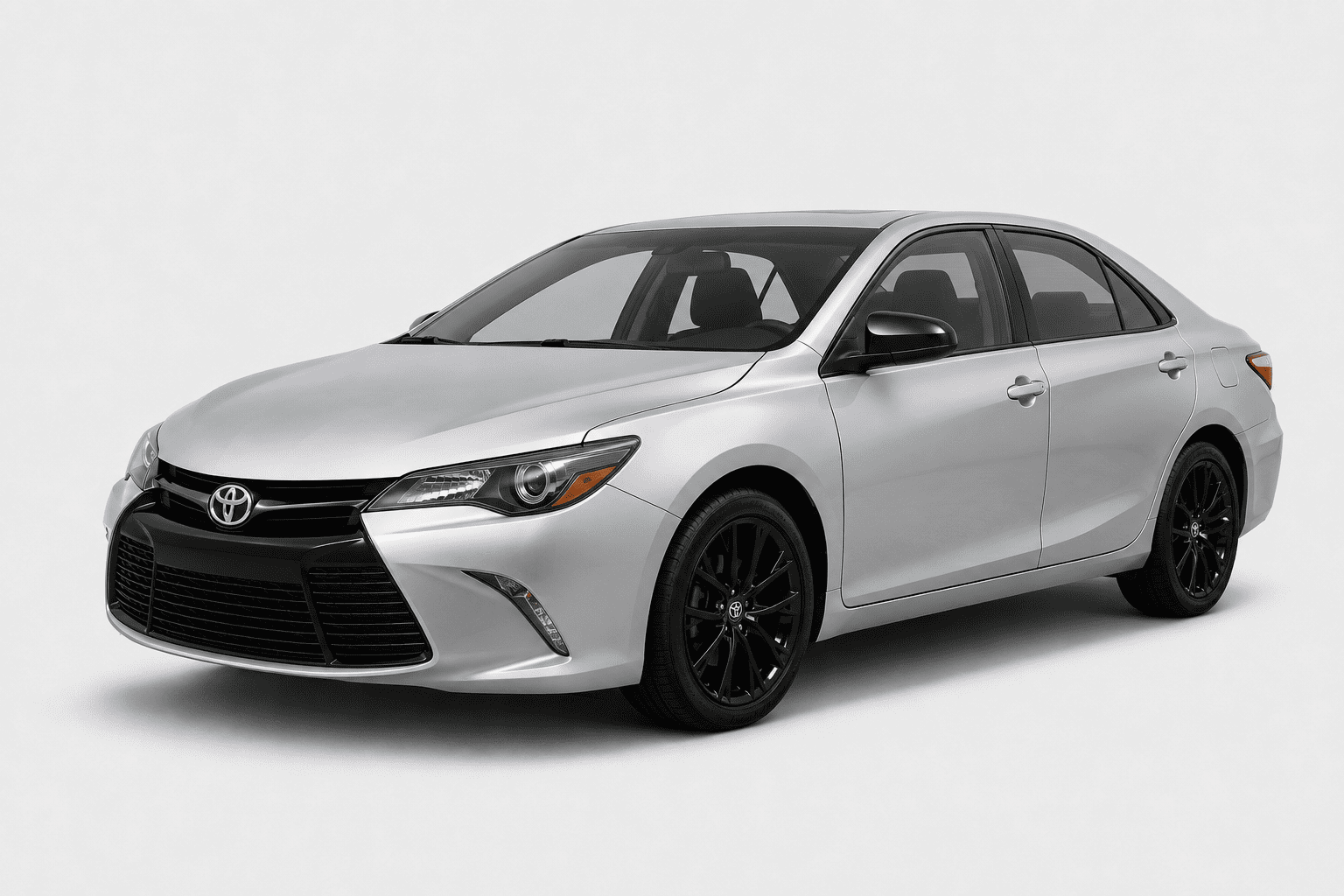 A silver Toyota Camry sedan with black wheels, shown from a three-quarter front angle on a light gray studio background.