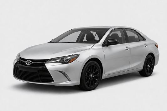 A silver Toyota Camry sedan with black wheels, shown from a three-quarter front angle on a light gray studio background.