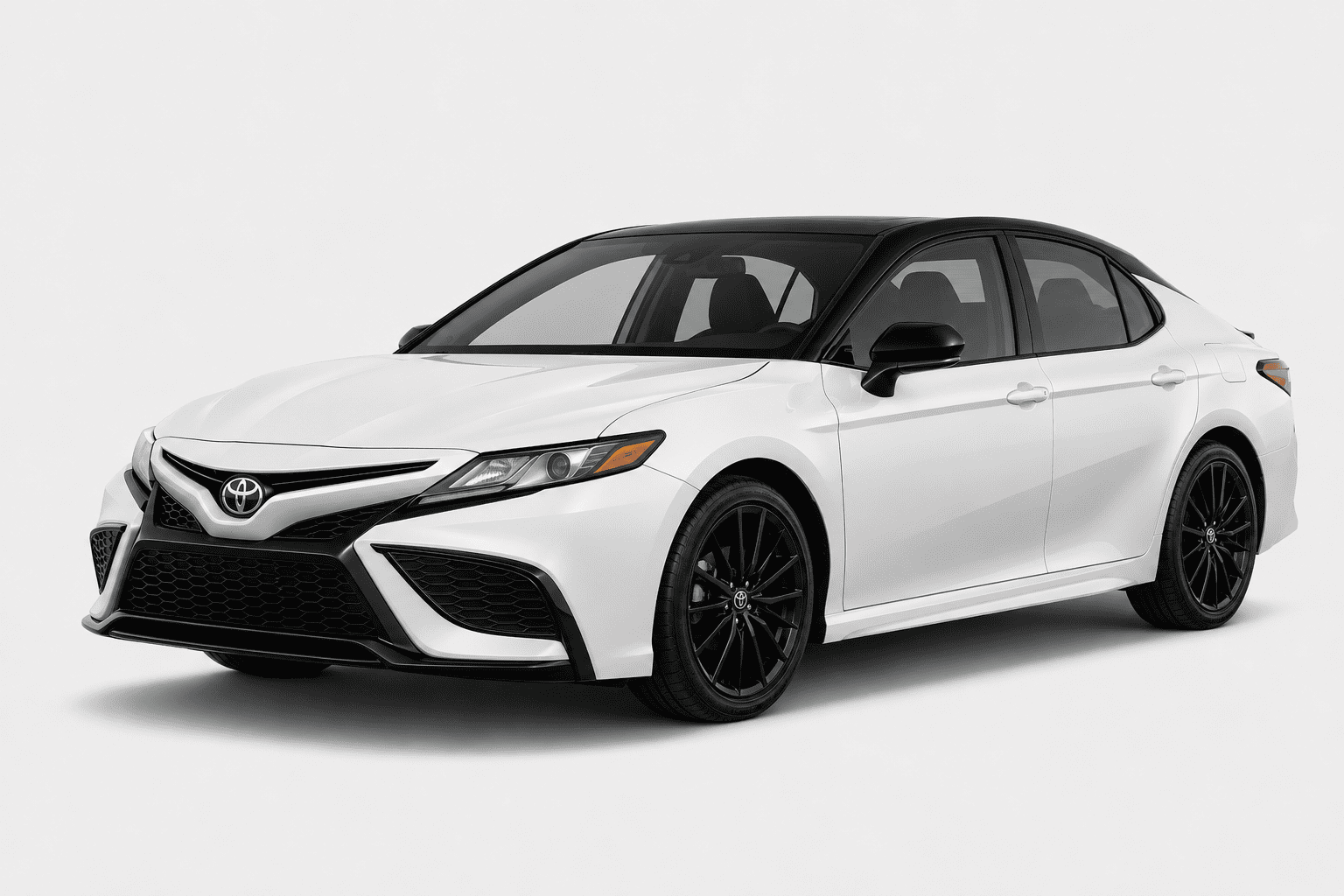 A white Toyota Camry sedan with black accents, including the roof, side mirrors, and wheels, shown from a three-quarter front angle on a light gray studio background.