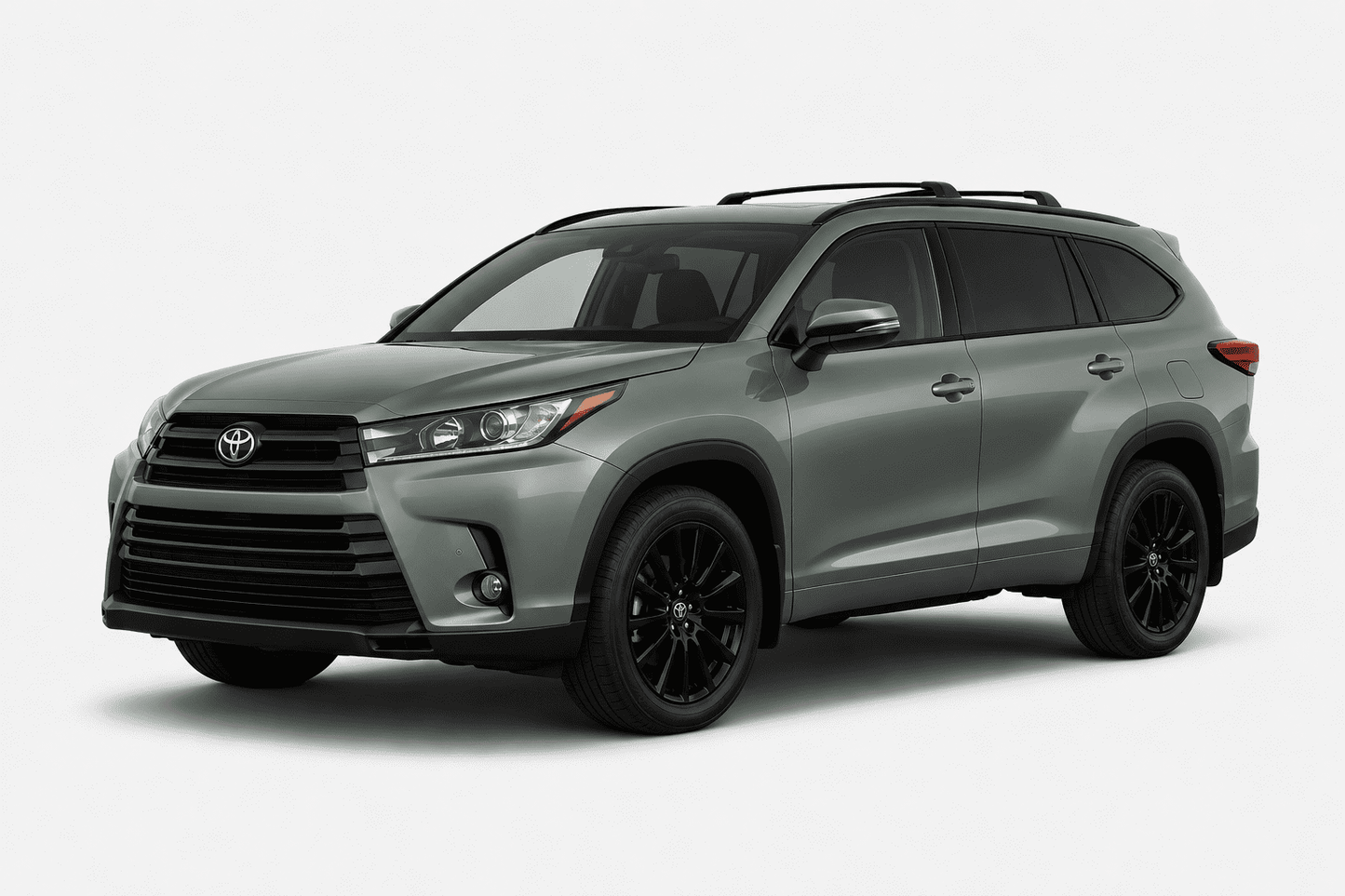 A silver-gray Toyota Highlander SUV with black wheels and roof rails, shown from a three-quarter front angle on a light gray studio background.