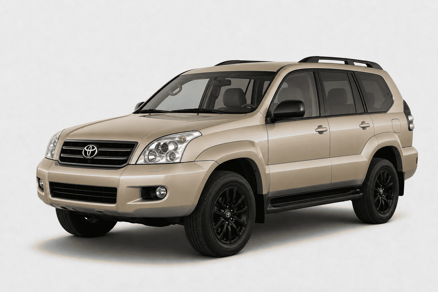 A beige Toyota SUV with black wheels and roof rails, photographed on a light gray studio background.