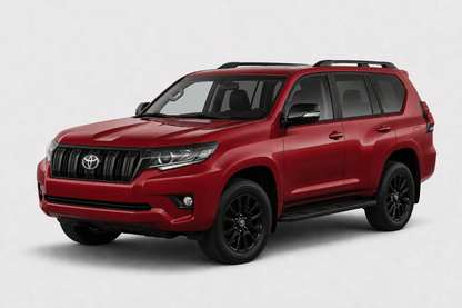 A red Toyota Land Cruiser SUV with black wheels and roof rails, photographed from a three-quarter front angle on a light gray studio background.