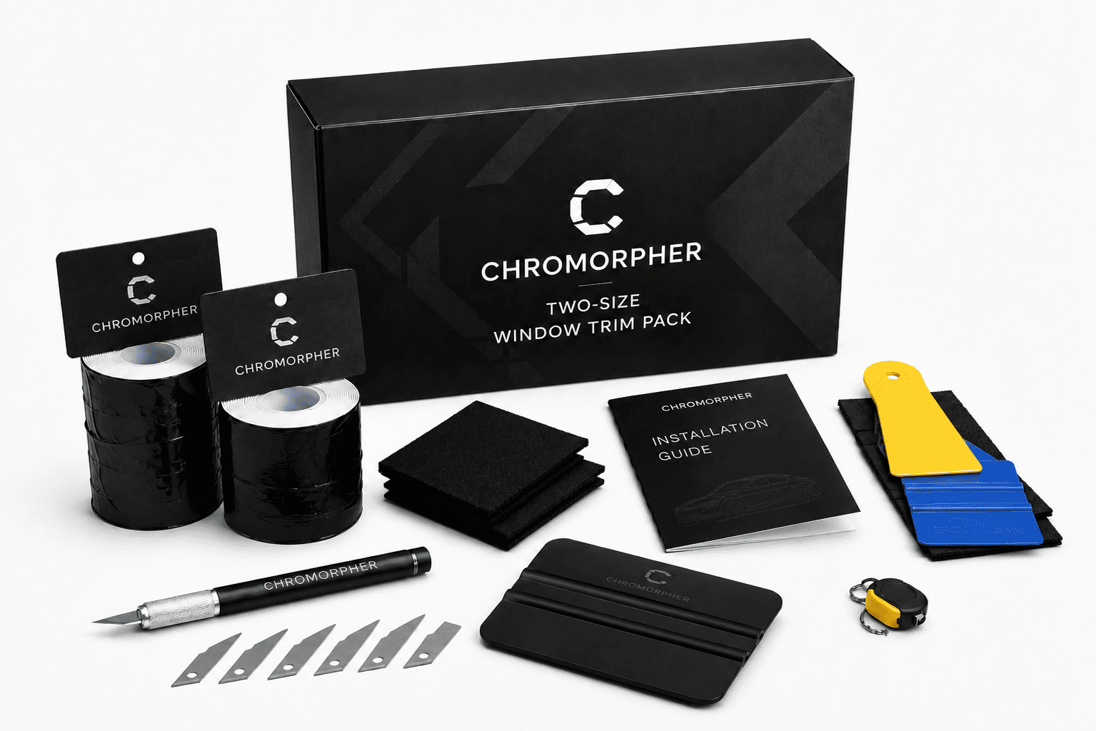 Chromorpher two-size window trim pack with black branded box, black adhesive rolls, black squeegees, blade strips, an installation guide, a pen, and a small yellow-and-blue accessory on a light gray background.
