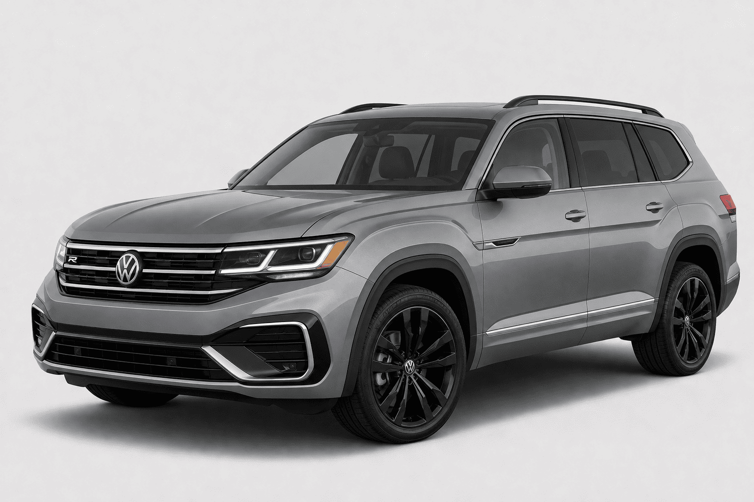 A silver Volkswagen Atlas SUV with black wheels and roof rails, photographed from a three-quarter front angle against a light gray studio background.