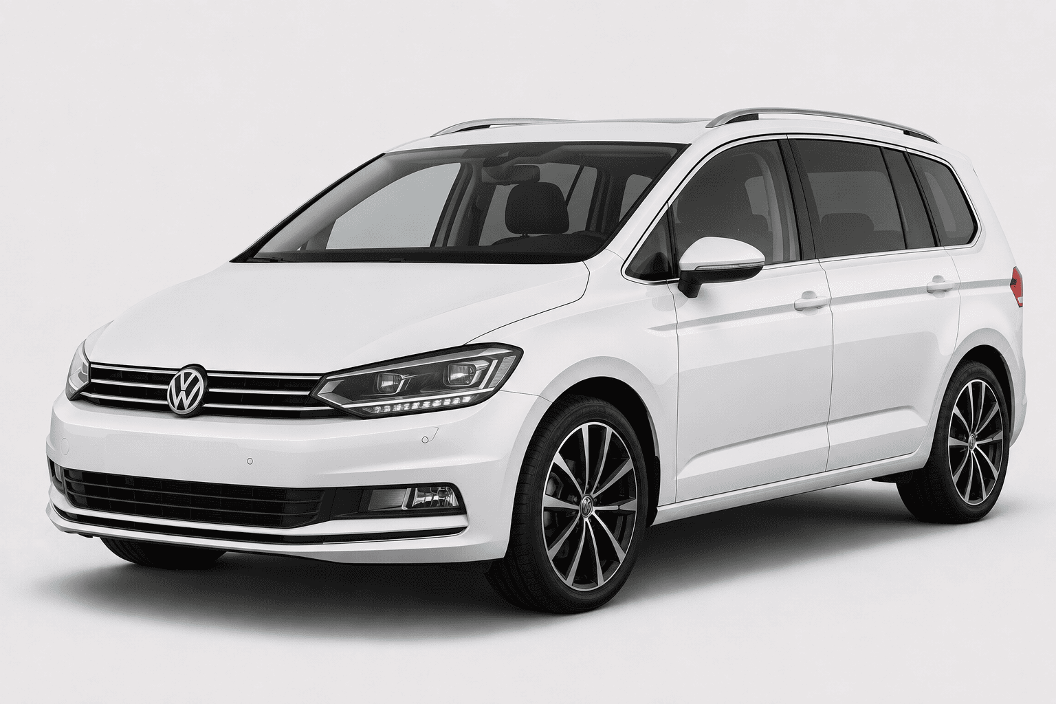A white Volkswagen Sharan minivan shown from a three-quarter front angle on a light gray studio background.